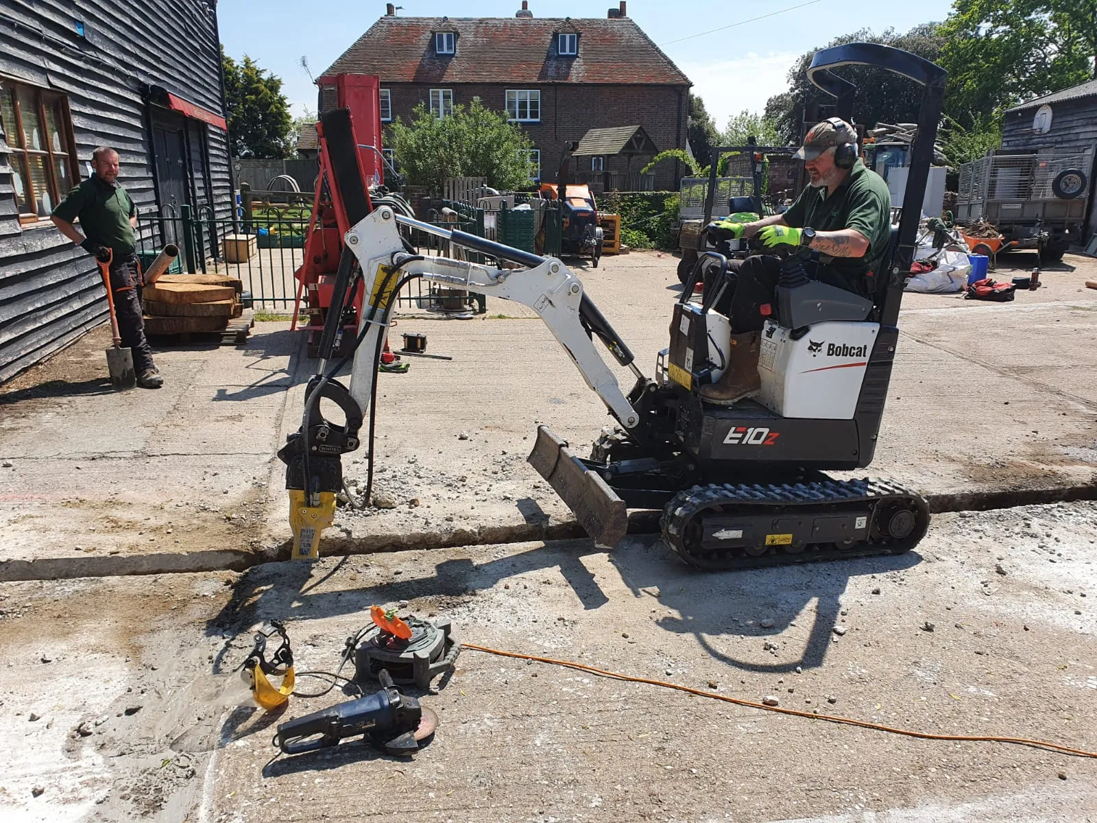 Bobcat E10z using a hydraulic breaker on concrete